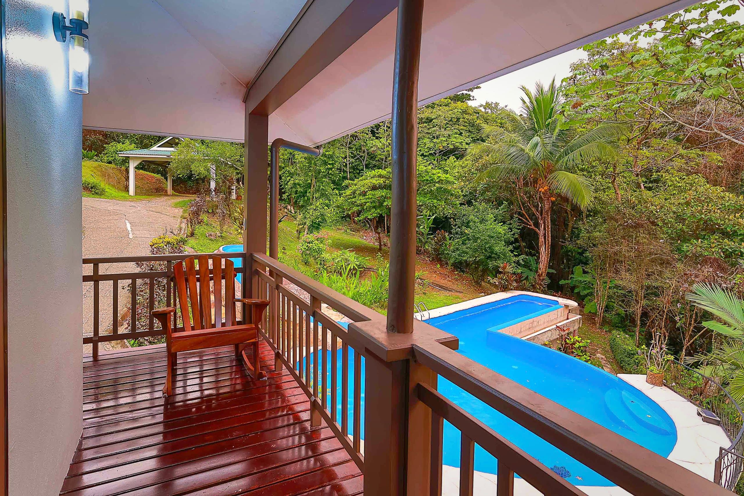 Wooden balcony overlooking the pool and jungle