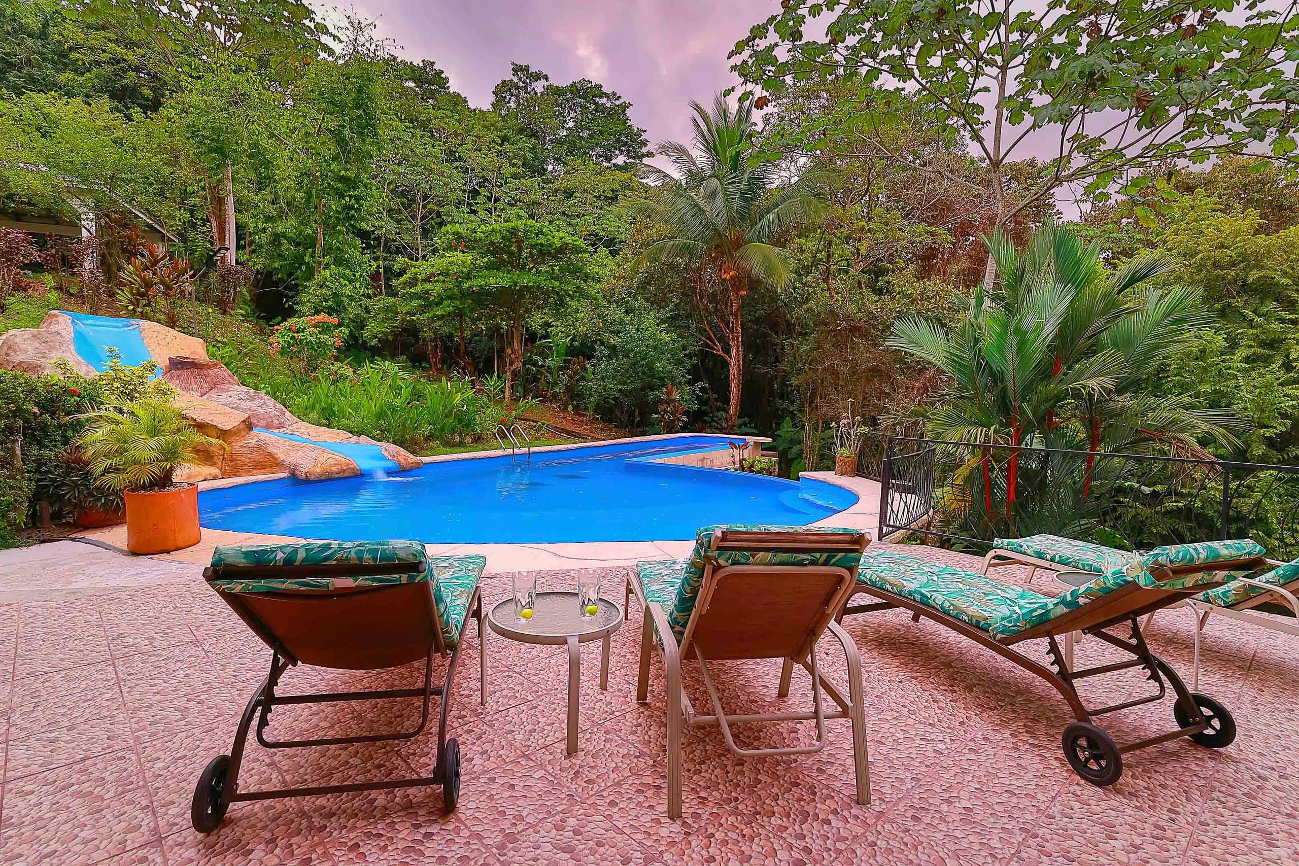 Sun loungers by the pool at dusk